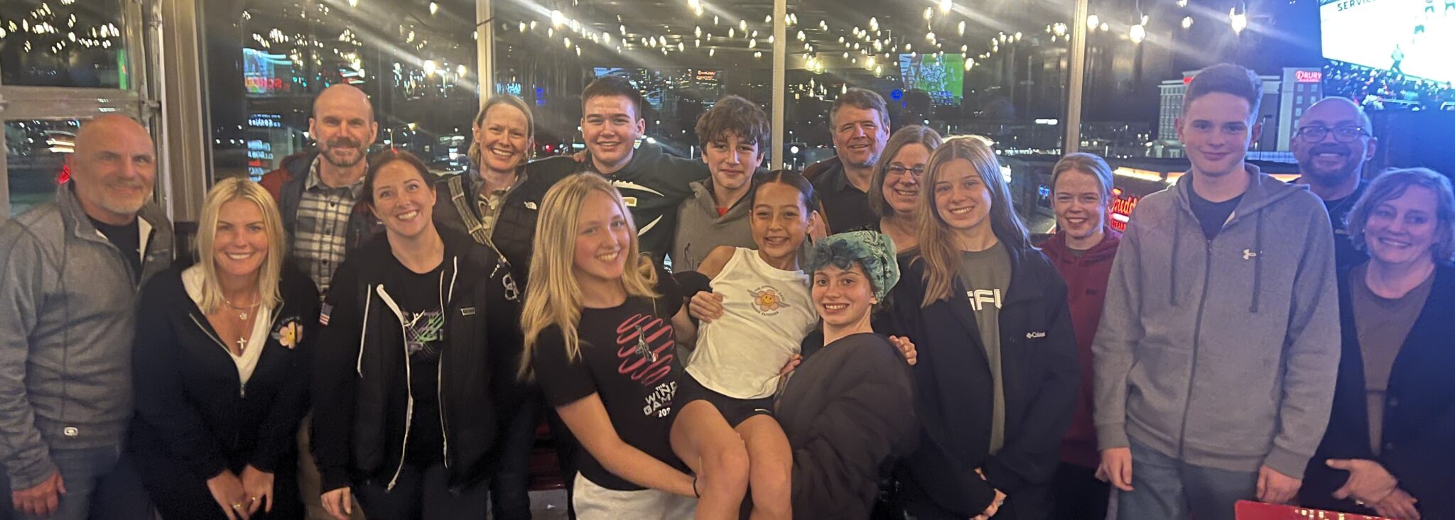 A large group of Children of Fallen Heroes families and young people gathered together for a photo in the evening.