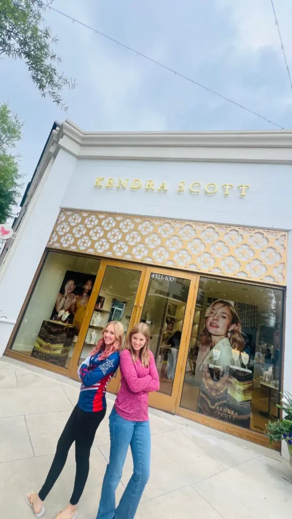 Children of Fallen Heroes NextGen athletes Emma Johnson and Kristen Blackmon standing outside a Kendra Scott store.