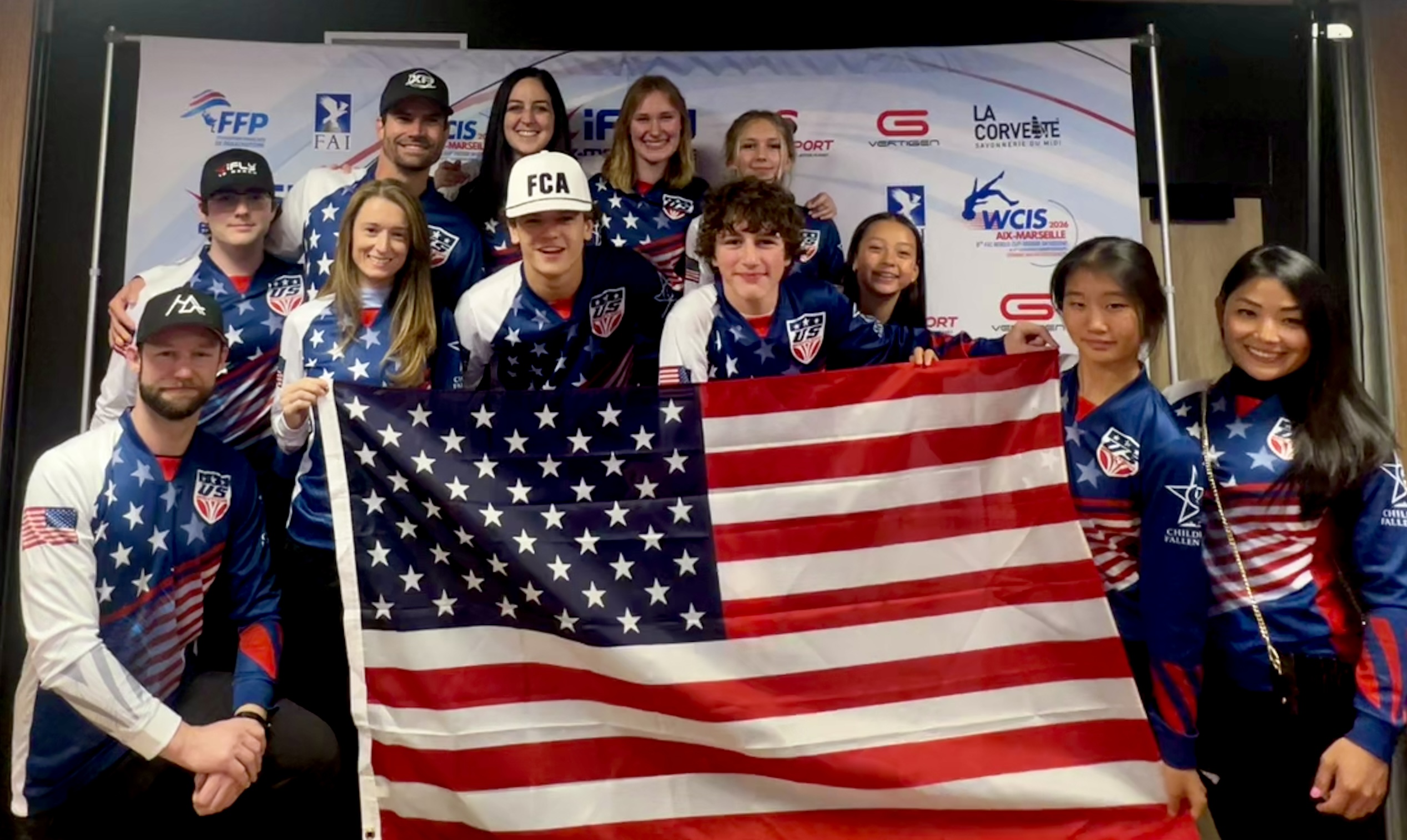 Children of Fallen Heroes athletes in Team USA gear holding the American flag