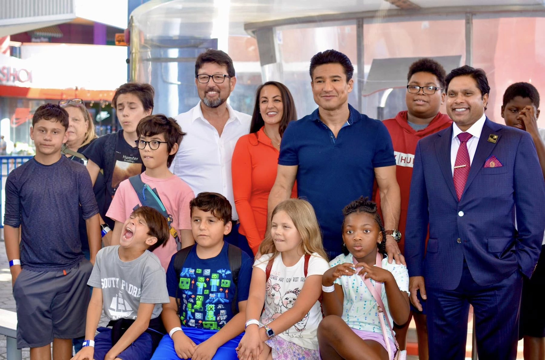 Children, families and supporters gathered together outside the indoor skydiving venue in California, with Mario Lopez standing among them.