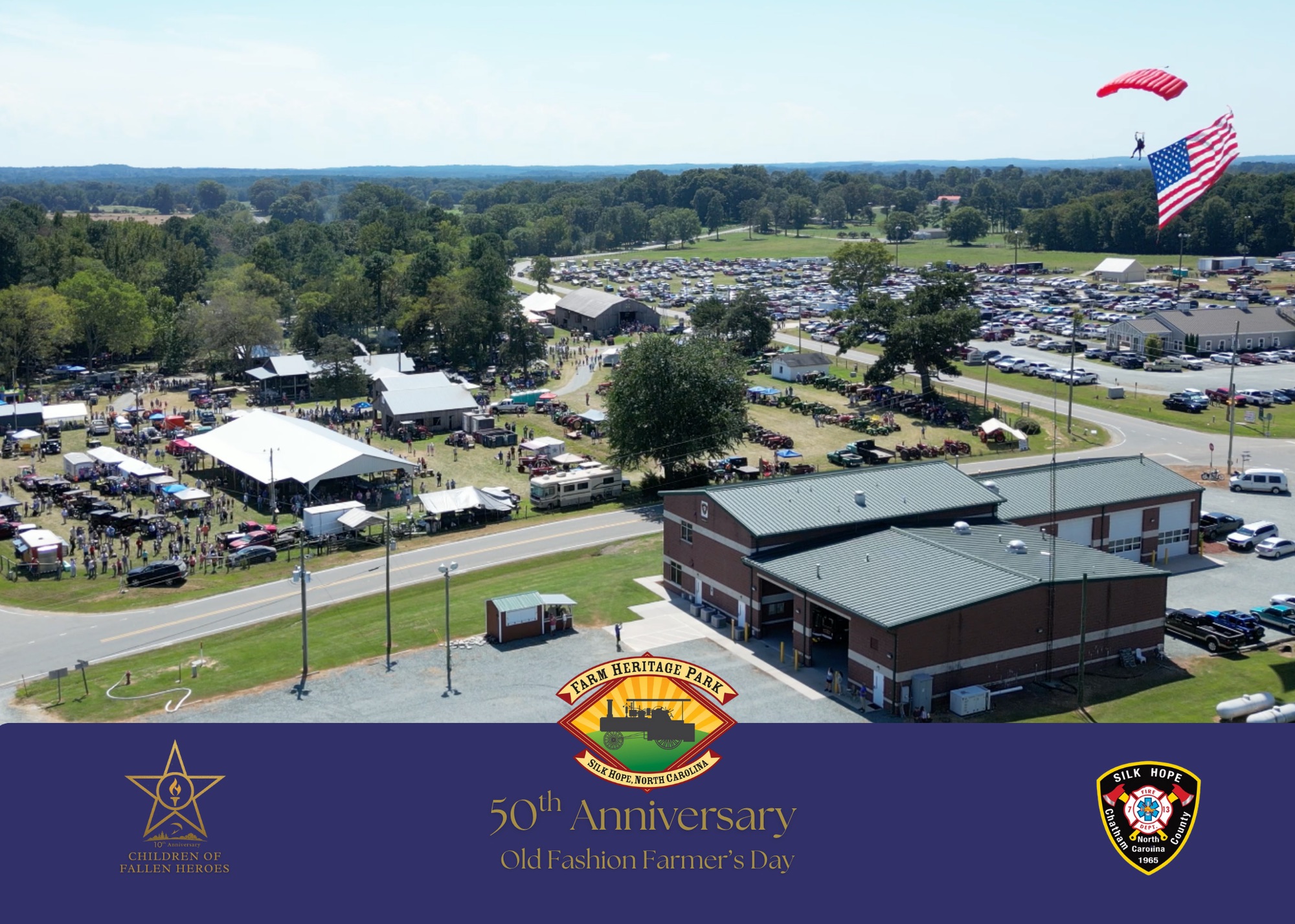 Aerial view of the 50th Anniversary Old Fashion Farmer&rsquo;s Day at Farm Heritage Park in Silk Hope, North Carolina, with a parachutist descending under an American flag.
