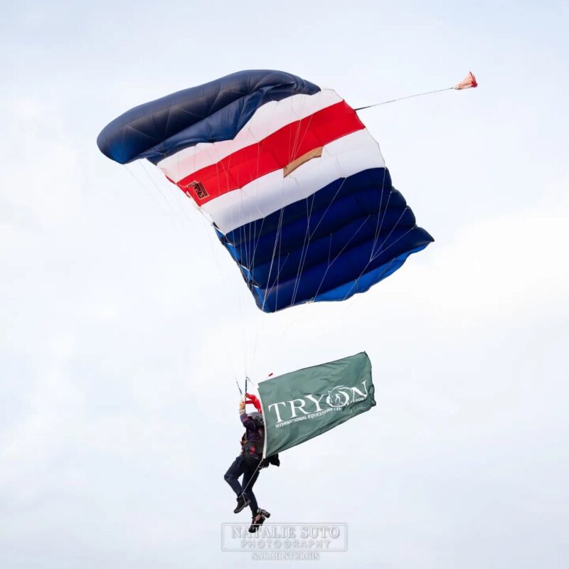 Adam Plummer of the CFH Parachute Team descending under canopy with the Tryon flag.