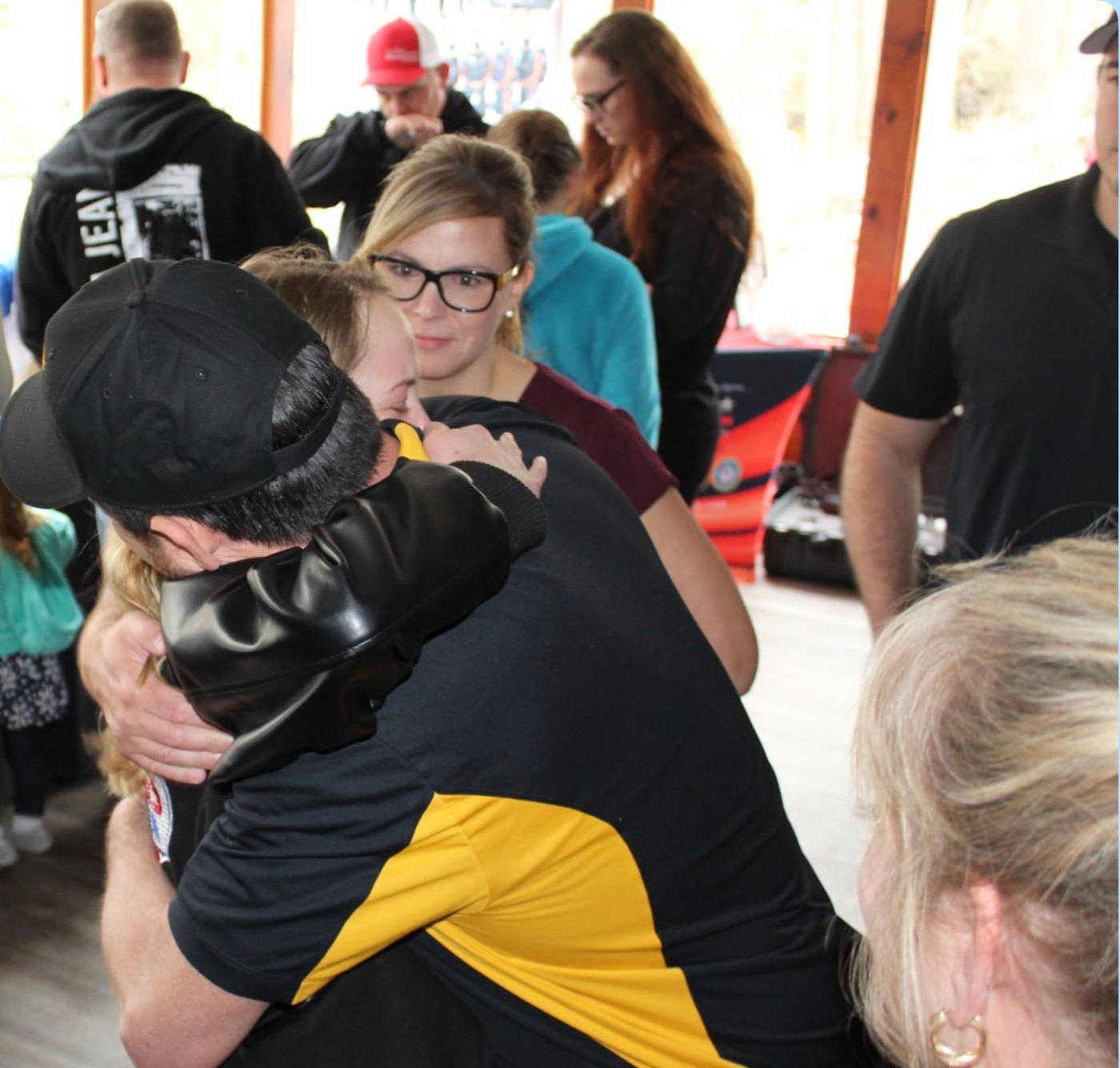 Courtney Dempsey receiving a hug from a member of the Children of Fallen Heroes team at the 2018 event in Raeford, North Carolina.